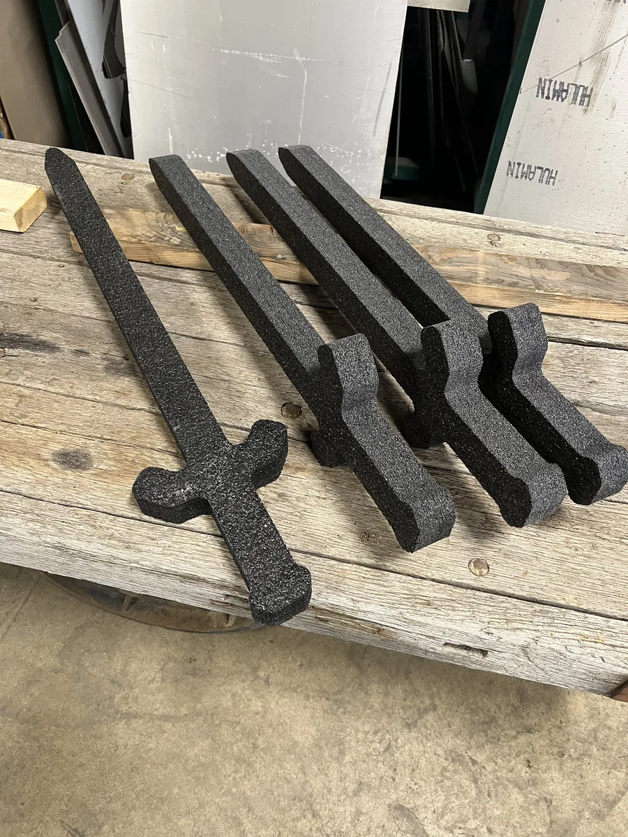 Set of custom-cut decorative sword and dagger shapes with textured black finish