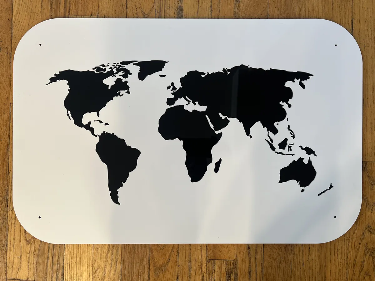 Waterjet-cut steel world map wall art with crisp, smooth continent edges