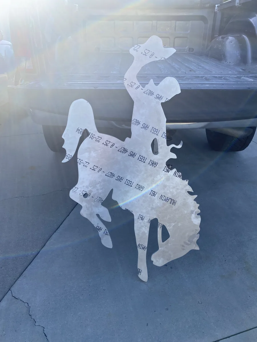 Waterjet-cut Wyoming bucking horse and rider silhouette mounted on a wall